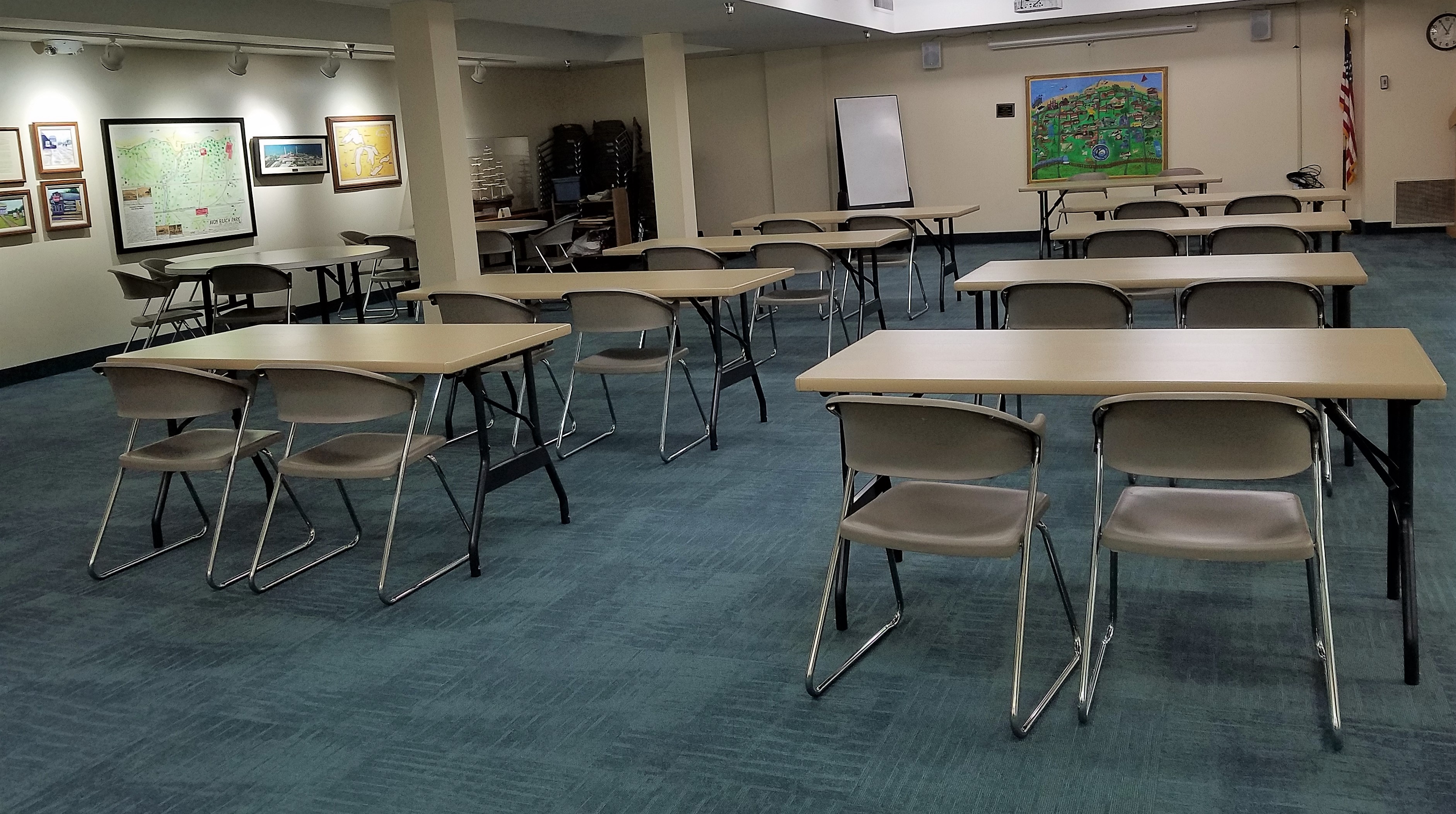 Room image showing a series of rectangular tables laid out classroom-style with circular tables to the left