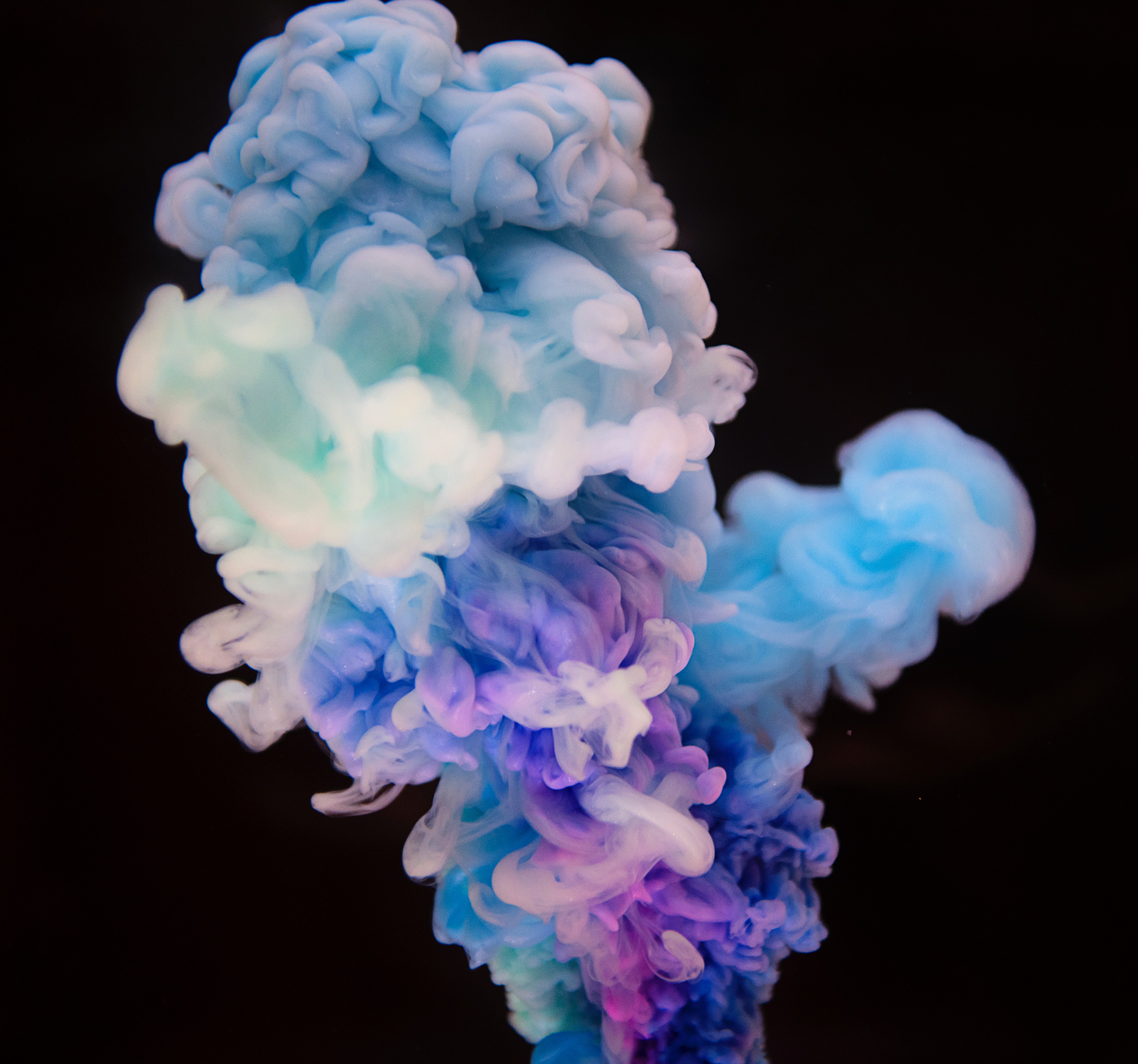 A multicolored smoke bomb set off under water