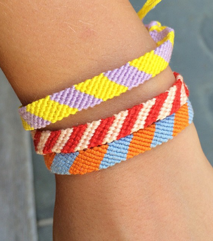 A teen shows off handmade woven friendship bracelets.