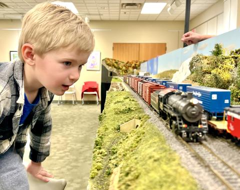 Little boy watching model trains 